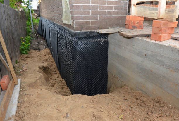 SJ Waterproofing Pros technician performing targeted Emergency Waterproofing assessment in Oakley, MI